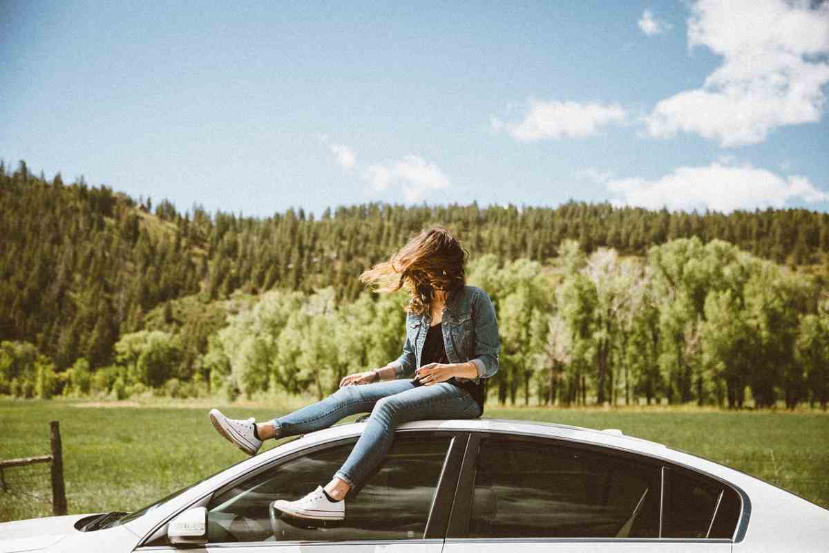 Ragazza sul tetto dell'auto