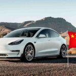 Una Tesla Model Y e una bandiera cinese sulla destra