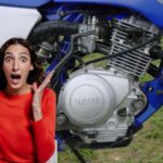 Una moto Yamaha e a sinistra una donna con espressione stupita