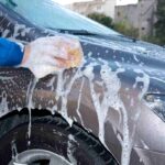 Lavaggio di un'auto con la spugna
