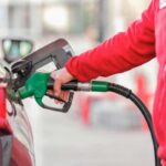 Un persona fa benzina al distributore