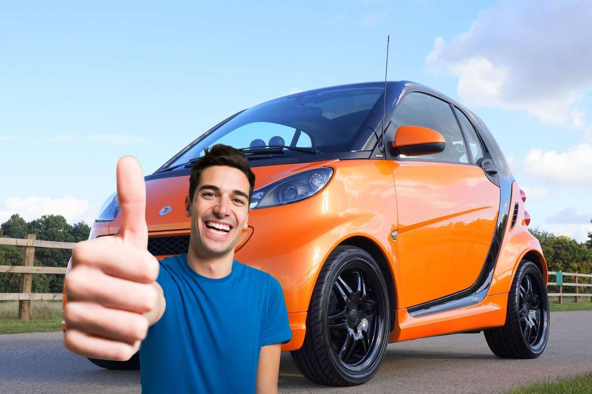 Una Smart e un ragazzo con il pollice in su
